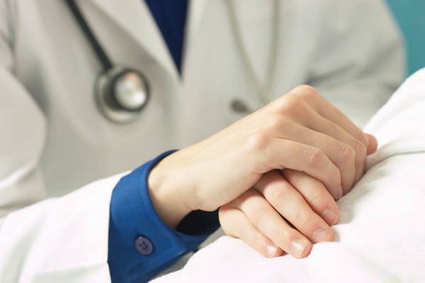 Doctor holding patient hand 2
